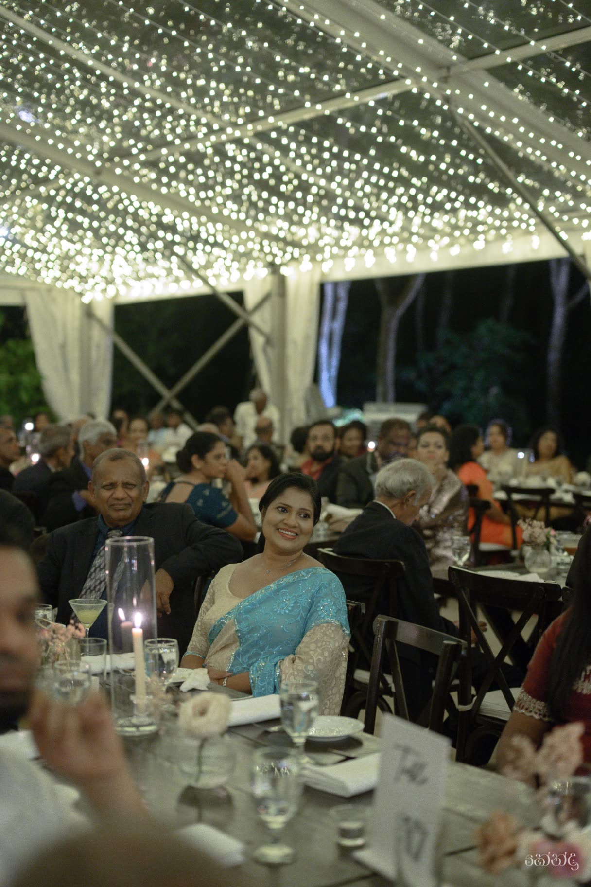 The reception dinner lit under the transparent marquee